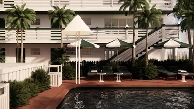 a hotel with a pool with chairs and umbrellas at Perroquet Hotel in Fort Lauderdale