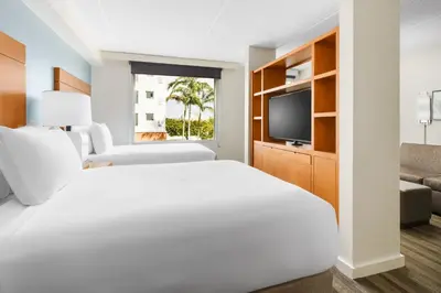 a hotel room with a bed and a tv at Hyatt House Fort Lauderdale Airport/Cruise Port in Dania Beach