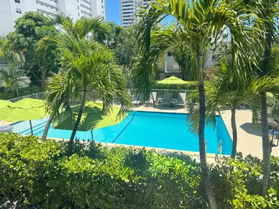 a swimming pool in a resort with palm trees at Park Royal Miami Beach in Miami Beach