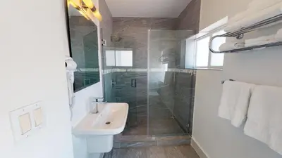 a bathroom with a sink and a glass shower at Park Royal Miami Beach in Miami Beach