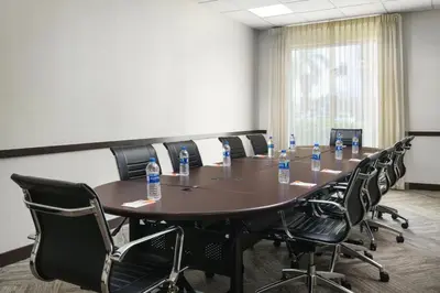 a conference room with a table and chairs with bottles of water at Hyatt Place Fort Lauderdale Airport/Cruise Port in Dania Beach