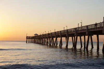 a pier stretches out into the ocean at sunset at Hyatt Place Fort Lauderdale Airport/Cruise Port in Dania Beach