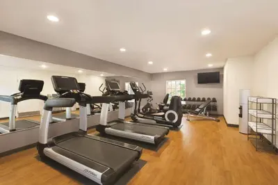 a gym with several treadmills and cardio machines at Hyatt House Miami Airport in Miami