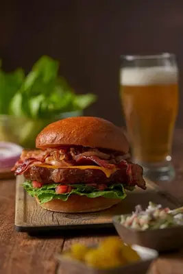 a sandwich on a table with a glass of beer at Hyatt House Miami Airport in Miami