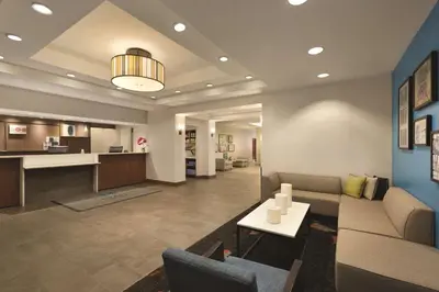 a living room with a couch and a table at Hyatt House Miami Airport in Miami