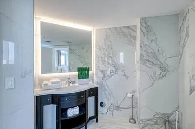 a bathroom with a sink and a mirror at Modern Ocean Drive Condo in the Heart of Sobe! in Miami Beach