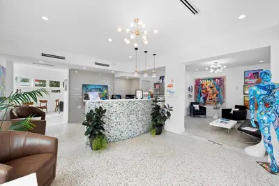 a living room with a bar in the middle at The New Yorker Hotel Miami in Miami