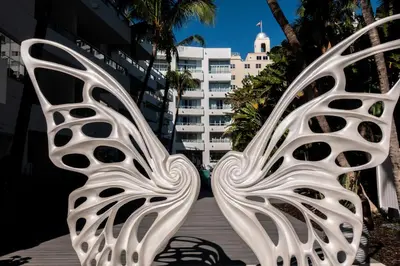 a metal bench in front of a building at The Sagamore Hotel South Beach in Miami Beach