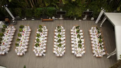 a group of tables and chairs with plates and tablesearcher at The Sagamore Hotel South Beach in Miami Beach