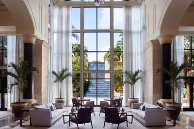a lobby with white furniture and large windows at The Ritz-Carlton Coconut Grove, Miami in Miami