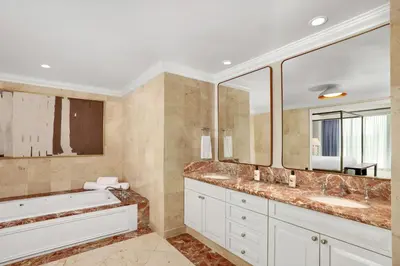a bathroom with two sinks and a large mirror at The Ritz-Carlton Coconut Grove, Miami in Miami
