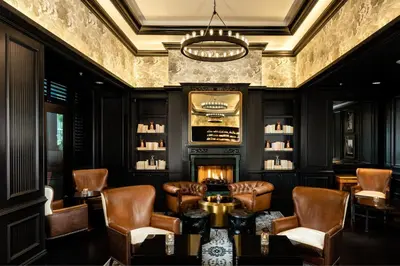 a living room with leather chairs and a fireplace at The Ritz-Carlton Coconut Grove, Miami in Miami