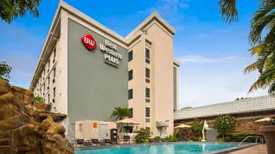 a hotel with a pool in front of it at Best Western Plus Hollywood/Aventura in Hollywood