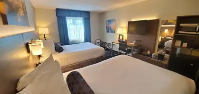 a hotel room with two beds and a television at Best Western Plus Hollywood/Aventura in Hollywood