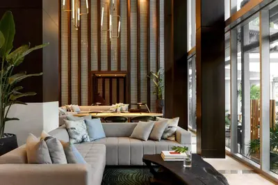 a living room with couches and a table at Kimpton EPIC Hotel by IHG in Miami