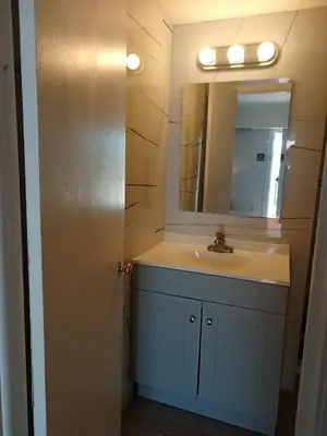a bathroom with a sink and a mirror at Pousada Suites at Hollywood Beach in Hollywood