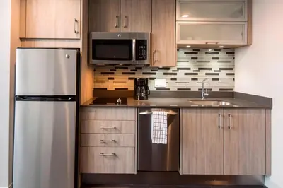a kitchen with a stainless steel refrigerator and a sink at Residence Inn Miami Sunny Isles Beach in Miami Beach