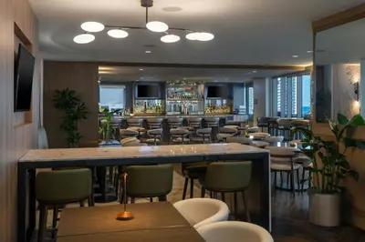 a bar in a restaurant with chairs and tables at Residence Inn Miami Sunny Isles Beach in Miami Beach