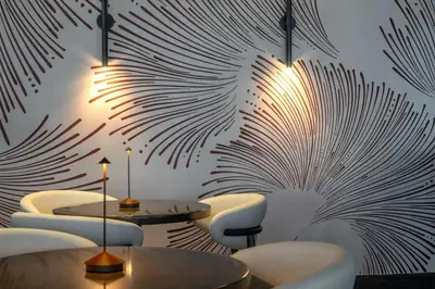 a restaurant with tables and chairs and a mural of leaves at Residence Inn Miami Sunny Isles Beach in Miami Beach
