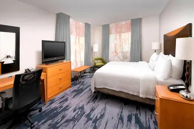 a hotel room with a bed and a desk and a television at Fairfield Inn & Suites by Marriott Miami Airport South in Miami