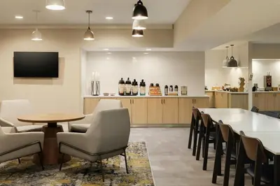 a dining room with chairs and a table and a bar at Fairfield Inn & Suites by Marriott Miami Airport South in Miami