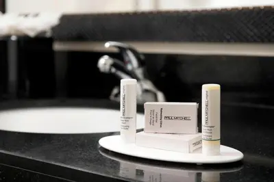 a bathroom counter with two complimentary toothbrushes and a sink at Fairfield Inn & Suites by Marriott Miami Airport South in Miami