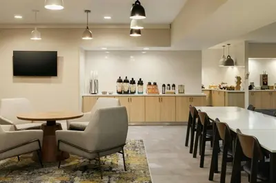 a restaurant with a table and chairs and a bar at Fairfield Inn & Suites by Marriott Miami Airport South in Miami