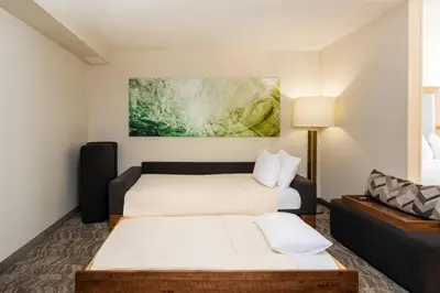 a hotel room with two beds and a couch at SpringHill Suites by Marriott Miami Airport South Blue Lagoon Area in Miami