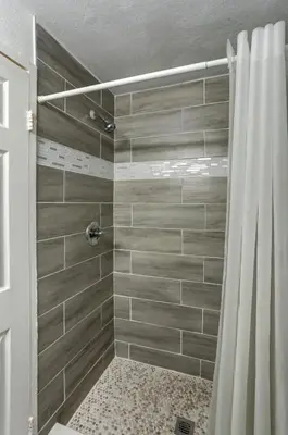 a shower with a shower curtain in a bathroom at Beach and Town Motel in Hollywood