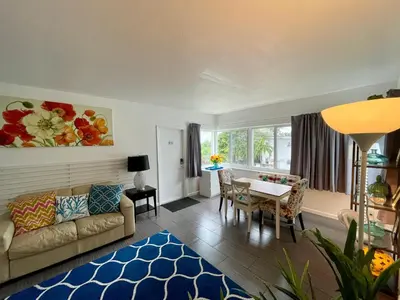a living room with a couch and a table at Nobleton Hotel in Fort Lauderdale