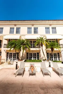 a woman sitting in a chair in front of a building at Hyatt Regency Coral Gables in Miami in Miami