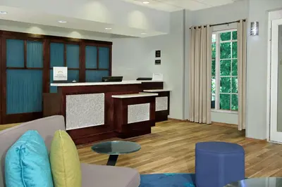 a living room with a couch and a counter at Homewood Suites by Hilton Miami - Airport West in Miami