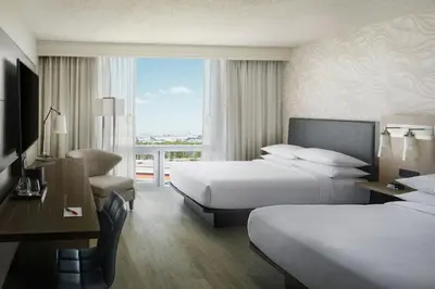 a hotel room with two beds and a window at Miami Airport Marriott in Miami
