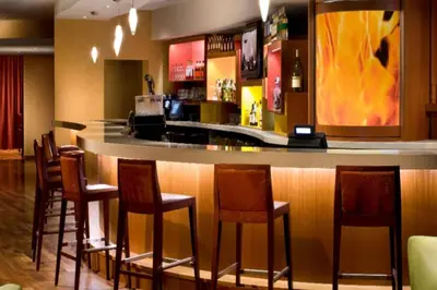 a bar in a restaurant with a bunch of bar stools at Miami Airport Marriott in Miami
