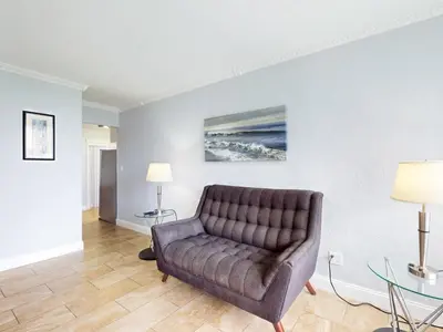 a living room with a couch and a table at The Grand Resort and Spa & Worthington All Male in Fort Lauderdale