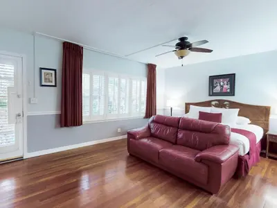 a living room with a bed and a couch at The Grand Resort and Spa & Worthington All Male in Fort Lauderdale
