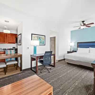 a hotel room with a bed and a desk at Homewood Suites by Hilton Fort Lauderdale Airport-Cruise Port in Dania Beach