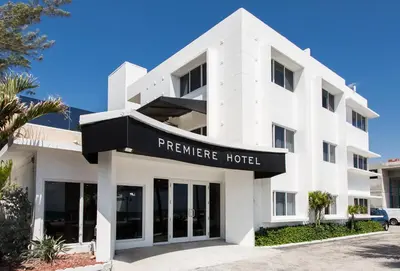 a white building with a sign for a hotel at Premiere Hotel in Fort Lauderdale