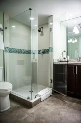 a bathroom with a glass shower with a toilet and a sink at The Mutiny Luxury Suites Hotel in Miami