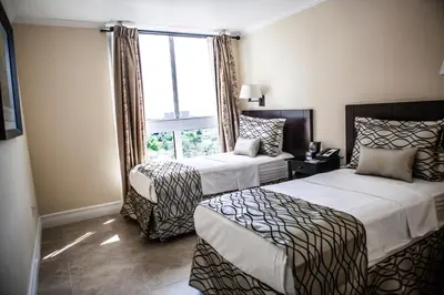 a hotel room with two beds and a window at The Mutiny Luxury Suites Hotel in Miami
