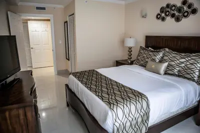 a bedroom with a bed and a flat screen tv at The Mutiny Luxury Suites Hotel in Miami