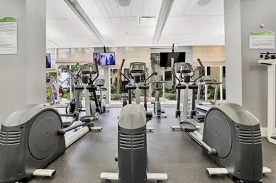 a gym with rows of treadmills and machines at The Tides-1 bedroom apartment Ground Floor in Hollywood