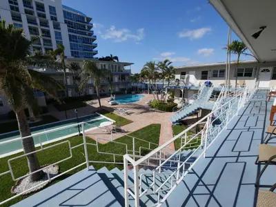 a view of the pool from the balcony of a resort at Holiday Isle Yacht Club in Fort Lauderdale