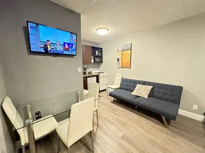 a living room with a couch and a dining room at Sheridan Guesthouse in Dania Beach