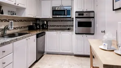 a white kitchen with white cabinets and appliances at THE TIDES 1bedroom apt 15th floor WE ARE ON THE BEACH! in Hollywood