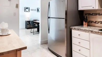 a stainless steel refrigerator in a kitchen with a table at THE TIDES 1bedroom apt 15th floor WE ARE ON THE BEACH! in Hollywood