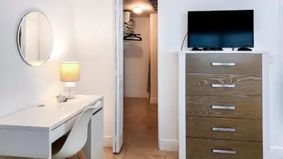 a room with a desk and a dresser with a television at THE TIDES 1bedroom apt 15th floor WE ARE ON THE BEACH! in Hollywood