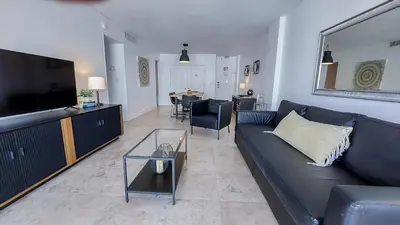 a living room with a blue couch and a television at THE TIDES 1bedroom apt 15th floor WE ARE ON THE BEACH! in Hollywood