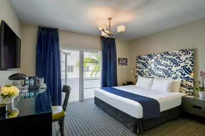 a hotel room with a bed and a balcony at Hotel Breakwater South Beach in Miami Beach