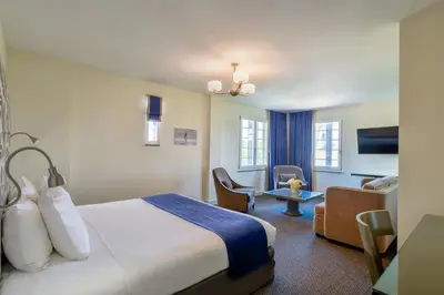 a hotel room with a bed and a chair at Hotel Breakwater South Beach in Miami Beach
